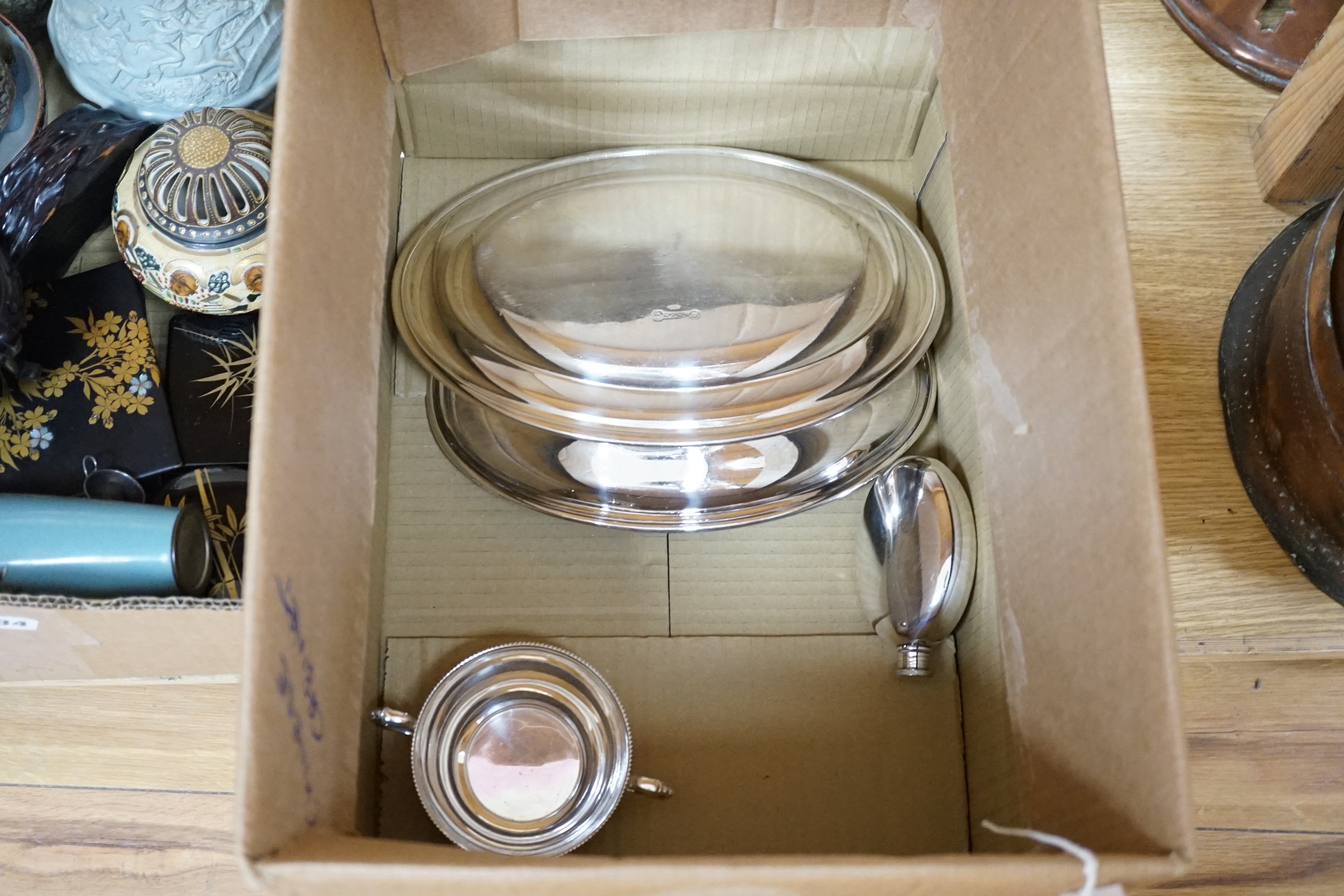 A group of silver plated ware, including four hip flasks